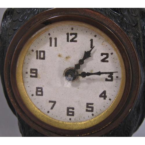 1402 - A spelter bedside or mantle clock in the form of an owl, with eight day time piece