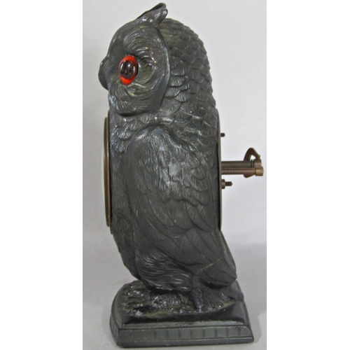 1402 - A spelter bedside or mantle clock in the form of an owl, with eight day time piece