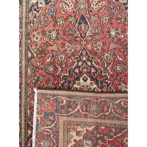 1695 - A Tabriz type carpet with an all over floral pattern on a pink and blue ground, 186cm x 125cm approx