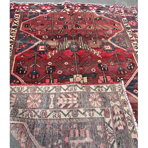 1697 - A middle eastern design carpet with a central vase of flowers and floral borders, 280cm x 208cm