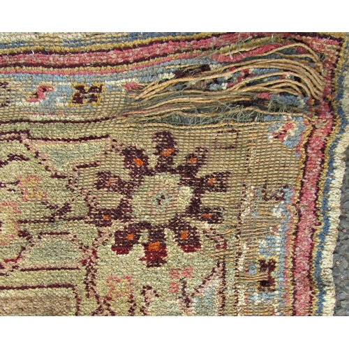 1709 - A large old worn and torn Donegall type carpet with a large floral pattern (af) together with others... 