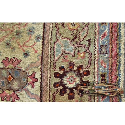 1709 - A large old worn and torn Donegall type carpet with a large floral pattern (af) together with others... 