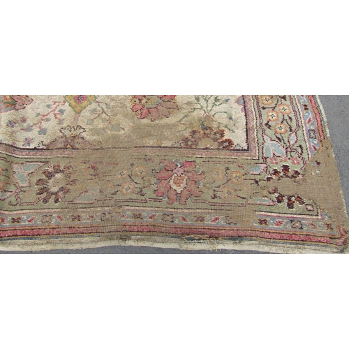 1709 - A large old worn and torn Donegall type carpet with a large floral pattern (af) together with others... 