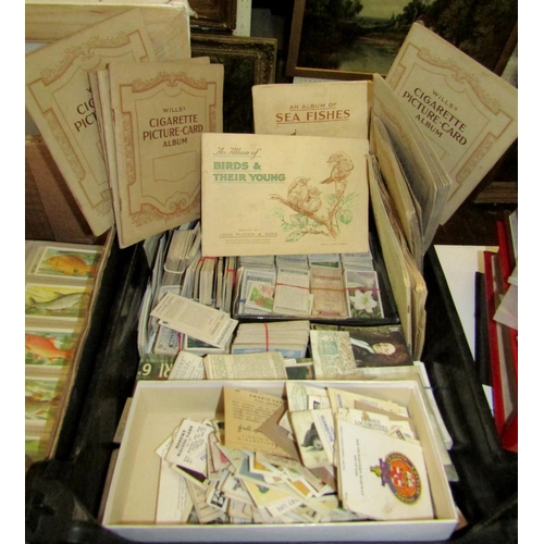 303 - A large collection of cigarette cards with examples by Will's and Players, the majority in albums to... 