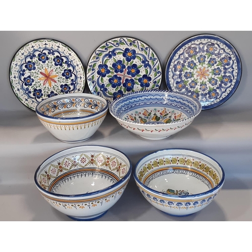 1126 - Four brightly painted continental pottery bowls with floral sprays, set within repeating borders, to... 