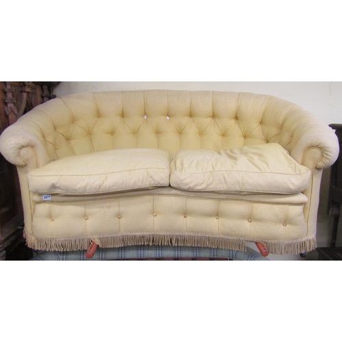 2677 - A small parlour room sofa with horseshoe shaped back and concave outline with buttoned finish in a p... 