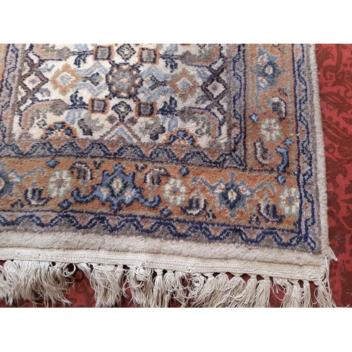 1713 - A narrow Middle Eastern runner with a repeating pattern in pale blues and brown, 330cm x 56cm approx... 