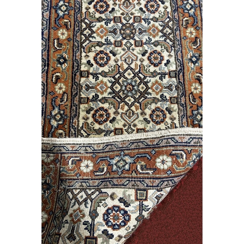 1713 - A narrow Middle Eastern runner with a repeating pattern in pale blues and brown, 330cm x 56cm approx... 