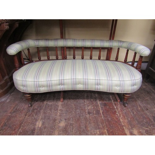 2674 - A small Edwardian drawing room settee, the horseshoe shaped back raised on turned spindles, the seat... 