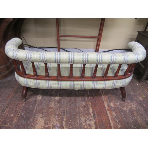 2674 - A small Edwardian drawing room settee, the horseshoe shaped back raised on turned spindles, the seat... 