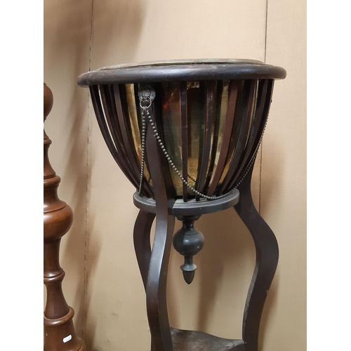 2120A - An Edwardian mahogany jardiniere stand with circular tapered brass liner within a slatted frame rais... 