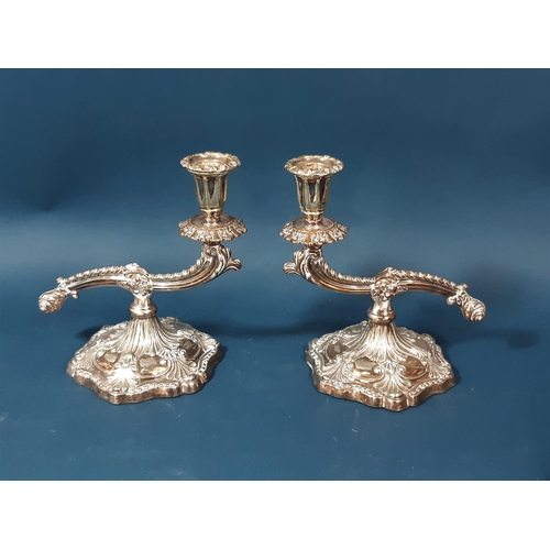 1180A - A mixed selection of silver plated table ware, including a pair of candlesticks, tureens, a three pi... 