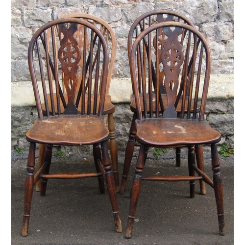 2668 - A set of four Windsor wheel back kitchen chairs principally in elm and ash