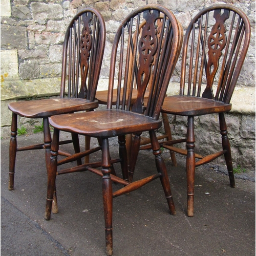 2668 - A set of four Windsor wheel back kitchen chairs principally in elm and ash