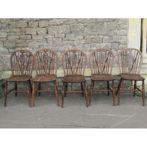 2156 - A set of five Windsor stained elm and beechwood hoop and stickback dining chairs with central pierce... 