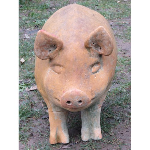 2087A - A weathered clay garden ornament in the form of a standing pig, 43cm H x 62 cm L approx