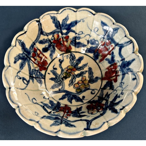 1041 - Chinese lobed bowl in under-glazed blue and red with grape and leaf decoration and seven character m... 