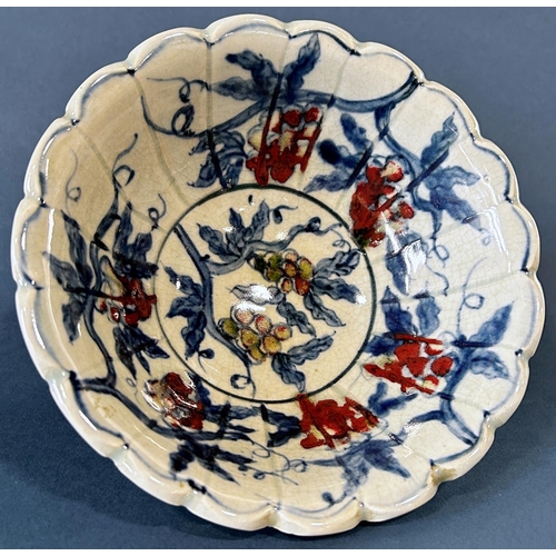 1041 - Chinese lobed bowl in under-glazed blue and red with grape and leaf decoration and seven character m... 