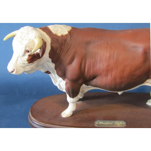 1060 - A Royal Doulton figure of a Hereford bull on a wooden plinth, height 18.5cm and a black Beswick hors... 