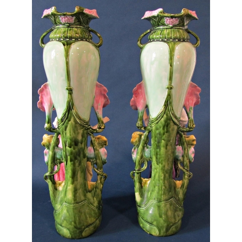 1063 - A substantial pair of art nouveau style majolica vases with floral vine decoration and large standin... 