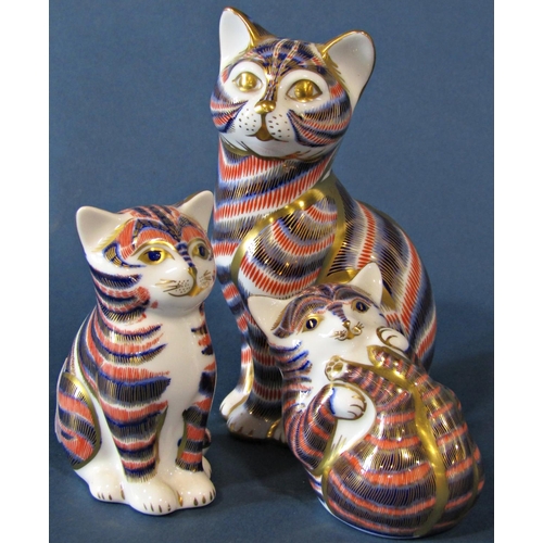 1072 - Three Royal Crown Derby ceramic cat figures together with a further Copenhagen example