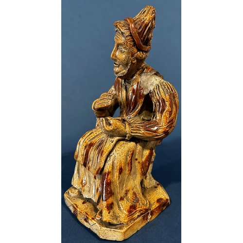 1078 - An early salt glaze model of an old woman taking snuff (af to hat)