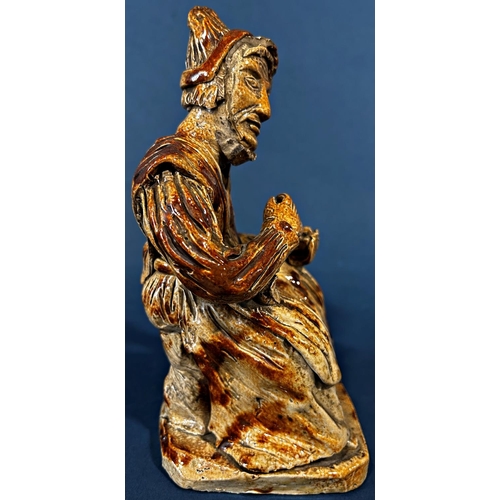 1078 - An early salt glaze model of an old woman taking snuff (af to hat)