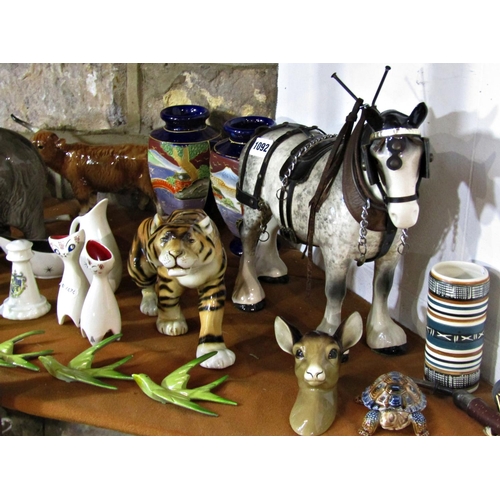 1092 - A collection of miscellaneous effects to include a bull elephant, a Royal Dux tiger, three Beswick p... 