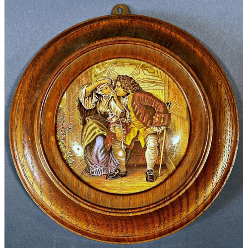 1082 - A collection of ceramic pot lids presented as wall plaques with wooden surrounds depicting various s... 