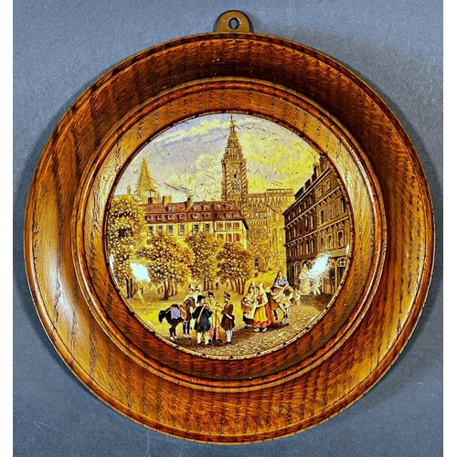 1082 - A collection of ceramic pot lids presented as wall plaques with wooden surrounds depicting various s... 