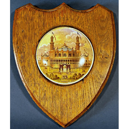 1082 - A collection of ceramic pot lids presented as wall plaques with wooden surrounds depicting various s... 