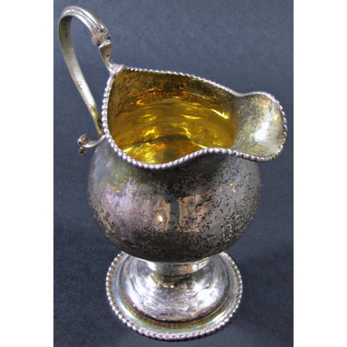 1224 - A George III silver gilt beaded cream jug, London 1774, maker Ann Chesterman, 13cm tall, 3oz approx