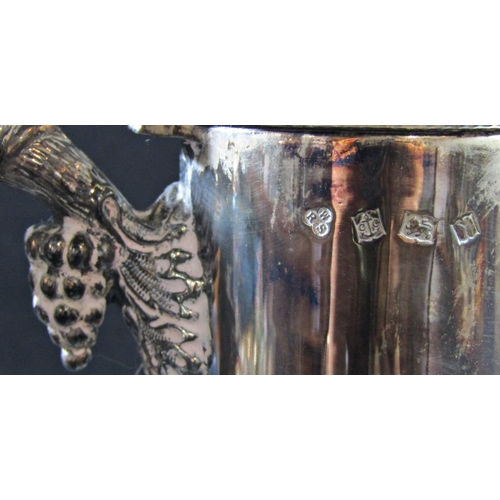 1226 - A Warwickshire reproduction silver ornate Georgian style claret jug with a grapevine twisted handle,... 