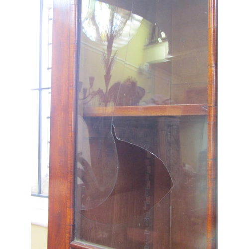 2625 - A Regency mahogany library bookcase, the lower section enclosed by two doors with brass grills and m... 