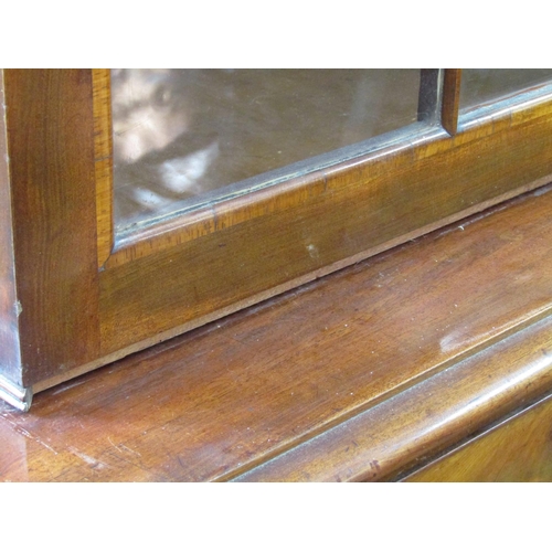 2625 - A Regency mahogany library bookcase, the lower section enclosed by two doors with brass grills and m... 