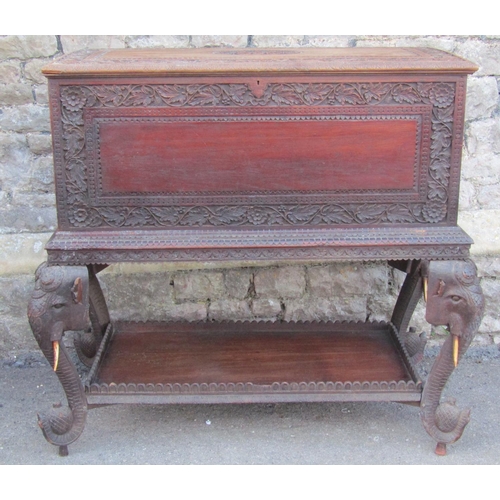 2630 - A 19th century Anglo Indian hardwood chest on stand, with rising lid and repeating carved foliate de... 