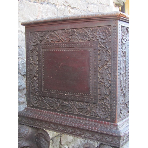 2630 - A 19th century Anglo Indian hardwood chest on stand, with rising lid and repeating carved foliate de... 