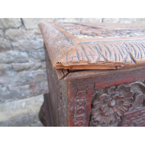 2630 - A 19th century Anglo Indian hardwood chest on stand, with rising lid and repeating carved foliate de... 