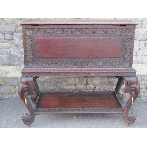 2630 - A 19th century Anglo Indian hardwood chest on stand, with rising lid and repeating carved foliate de... 