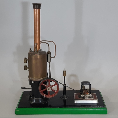 329 - A live steam display layout comprising a vertical steam engine with 7cm/3