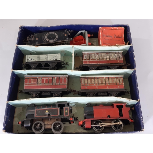 344 - A collection of Hornby O gauge clockwork railway locomotives, wagons and track including boxed Tank ... 