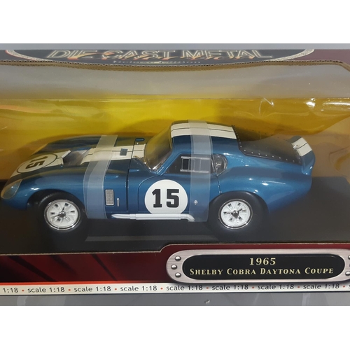 348 - 2 boxed die-cast models of sports cars, both 1:18 scale and not removed from boxes, comprising 1965 ... 