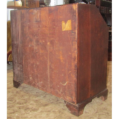 2300 - A Georgian mahogany bureau, the fall flap enclosing a fitted interior of small drawers, pigeon holes... 