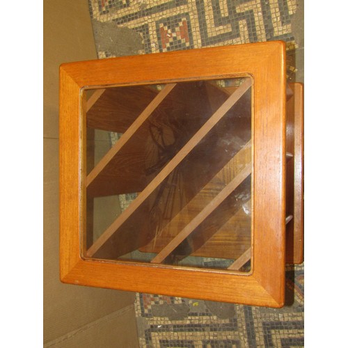 2329 - A retro teak freestanding hall stand, the raised back with applied mirror plate over a frieze drawer... 