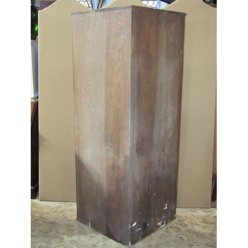 2328 - Reproduction oak floorstanding corner cabinet enclosed by two doors, with carved detail