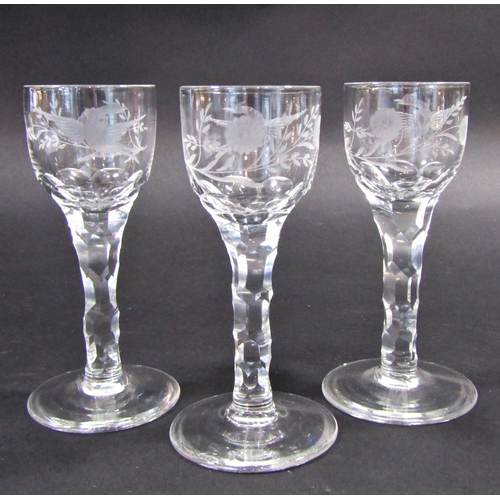 1154 - Three 19th century floral and bird engraved, cut glass wine glasses on faceted stems 14.5cm tall.