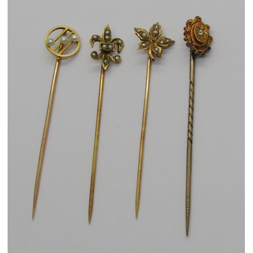 1256 - Four antique gold stick pins; 14k maple leaf example set with seed pearls (centre pearl vacant) cont... 