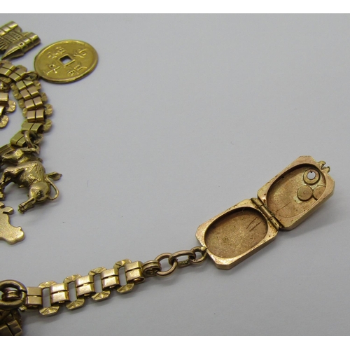 1266 - 14k charm bracelet hung with thirteen novelty charms, mostly Eastern themed, to include a long boat,... 