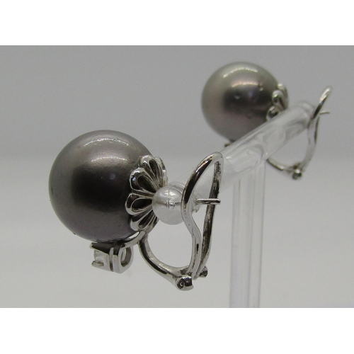 1276 - Pair of Tahitian pearl earrings with 18ct white gold clip fastenings, each set with a diamond 0.20ct... 