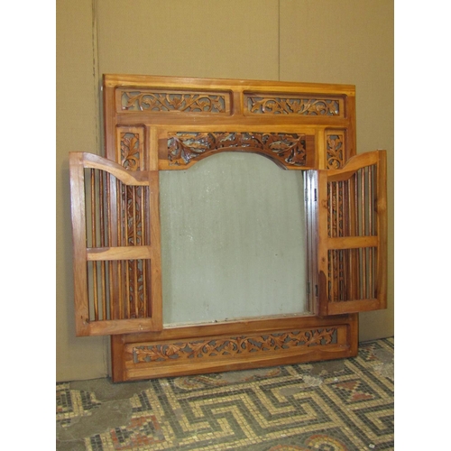 2379 - A contemporary eastern wall mirror enclosed by a hardwood frame repeating pierced floral surround, 8... 